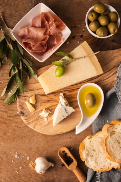 Flat lay parmesan and prosciutto on cutting board