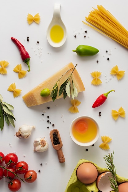 Flat lay parmesan uncooked pasta and ingredients