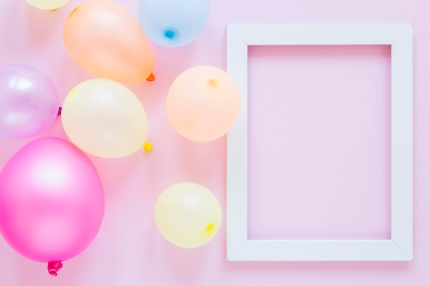 Flat lay party balloons and frame