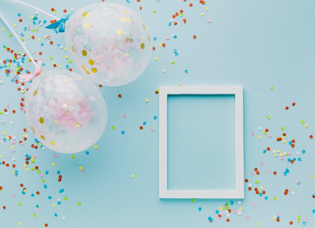 Flat lay party decoration with balloons and frame