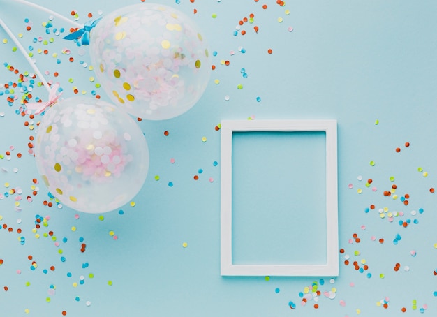 Flat lay party decoration with balloons and frame