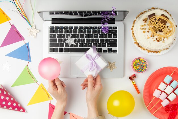 Flat lay party decorations and  laptop