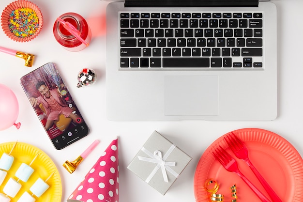 Flat lay party decorations with laptop