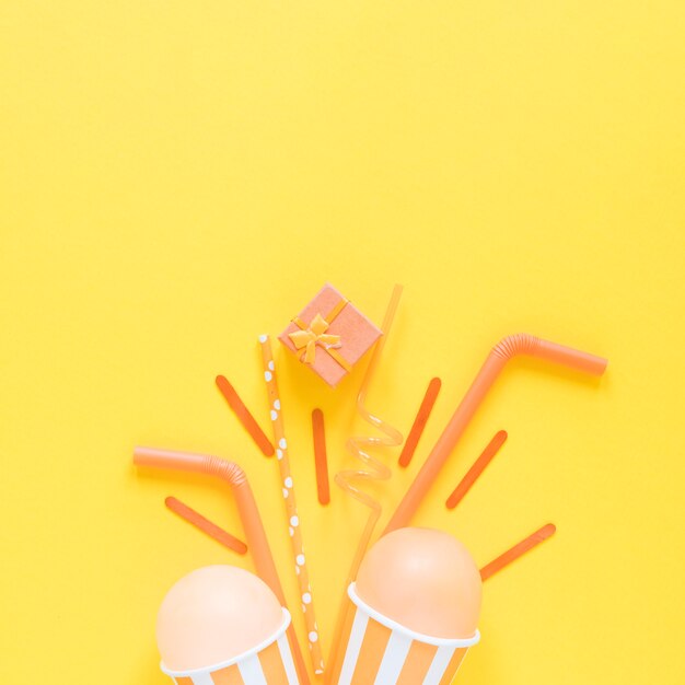 Flat lay party items on yellow background