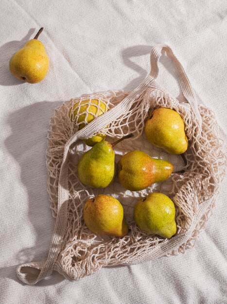 Flat lay  pears on net bag arrangement