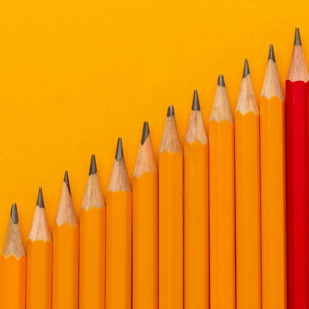 Flat lay pencils on orange background
