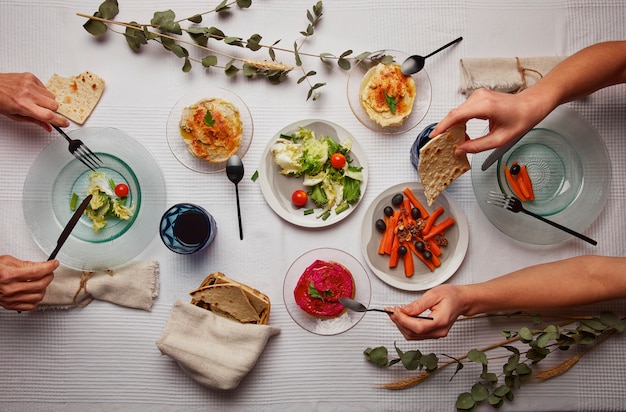 Free photo flat lay of people having a feast for the first day of passover seder