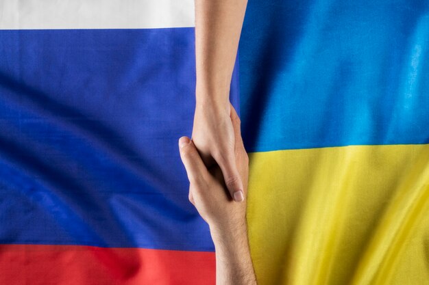 Flat lay people holding hands with flags