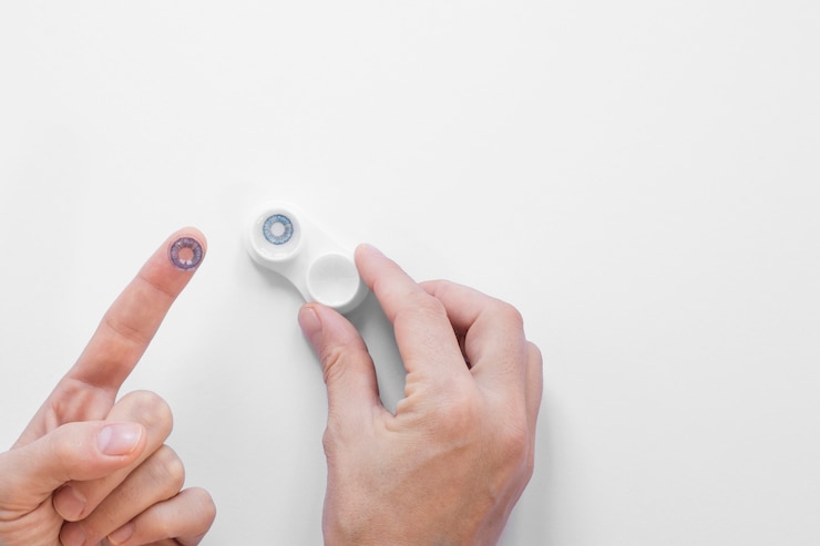 Free Photo flat lay person holding eye contacts with copy space