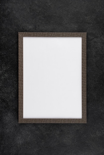 Flat lay of photo frame on textured surface