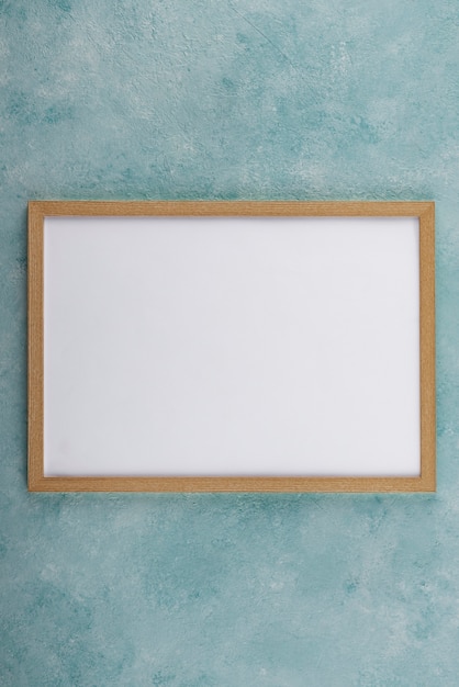 Flat lay of photo frame on textured surface