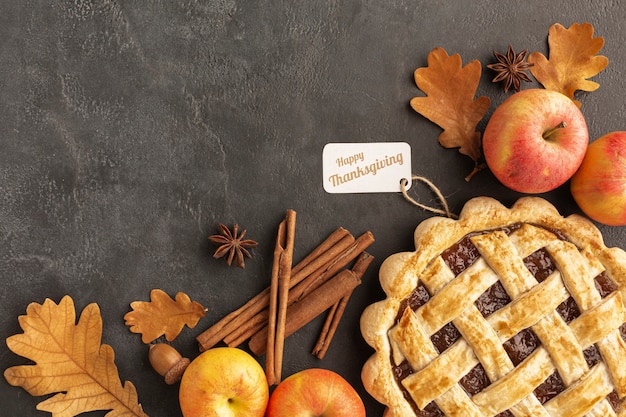 Flat lay pie and apples on stucco background