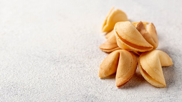 Flat lay pile of fortune cookies with copy space