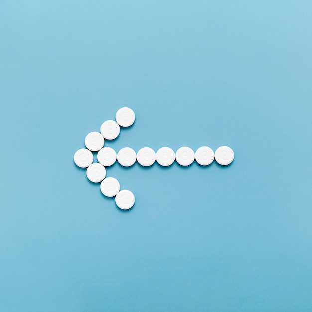 Flat lay of pills in arrow shape