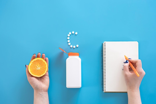 Free photo flat lay pills on blue background vitamin c concept