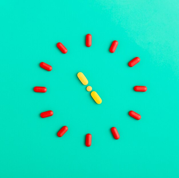 Flat lay of pills forming a clock