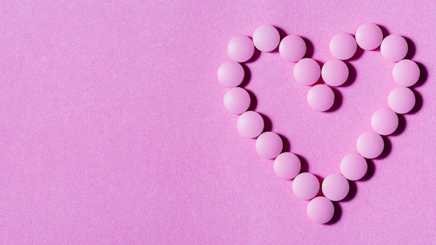 Flat lay pills on purple background