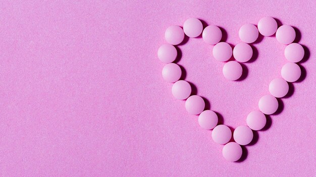 Flat lay pills on purple background