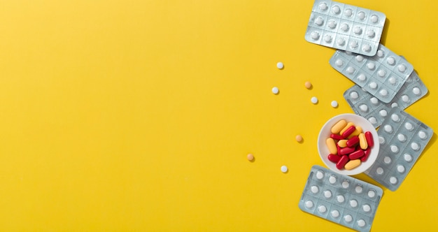 Flat lay of pills with foils and copy space