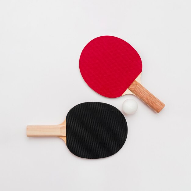 Flat lay of ping pong paddles with ball