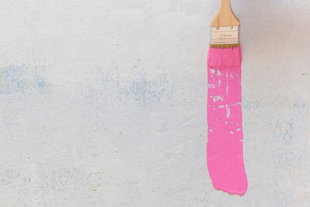 Flat lay of pink paint brush with copy space