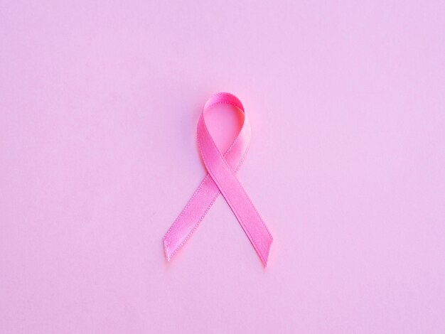 Flat lay pink ribbon and background