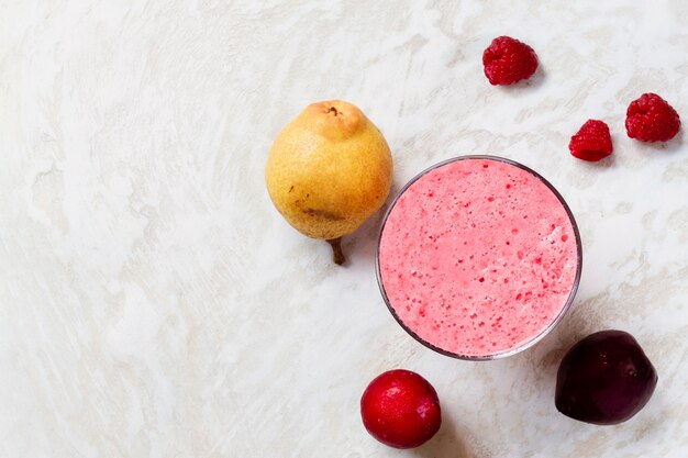 Flat lay pink smoothie in glass