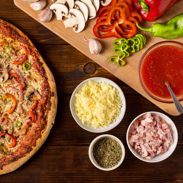 Flat lay pizza with pepper and ingredients