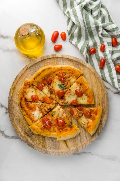 Flat lay of pizza with tomatoes and oil