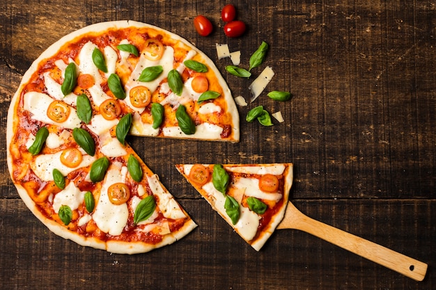 Flat lay of pizza on wooden table