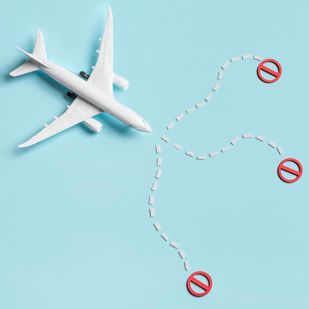 Flat lay plane toy on blue background