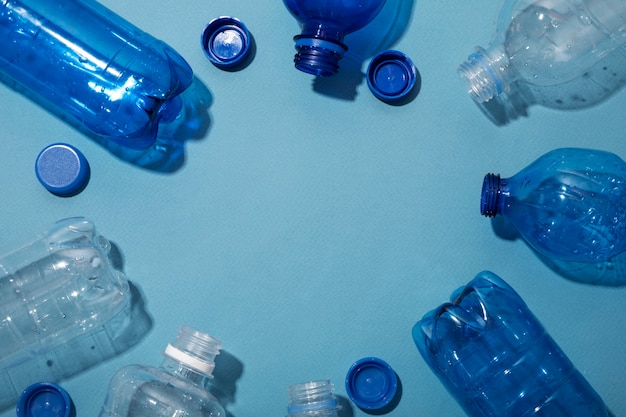 Flat lay plastic bottles with copy space