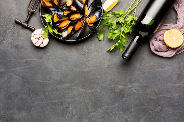 Flat-lay plate of cooked mussels with copy space