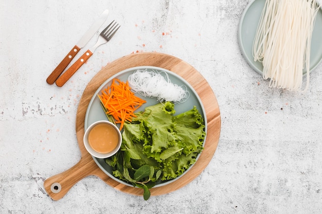 Flat lay of plate of fresh vegetables and noodles