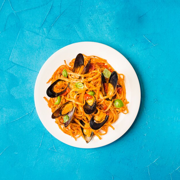 Flat-lay plate of pasta with mussels 