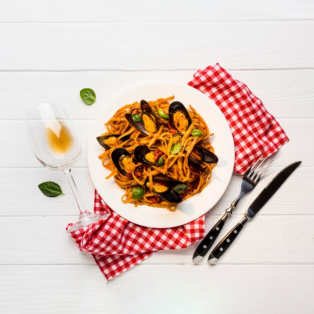 Flat-lay plate of pasta with mussels 