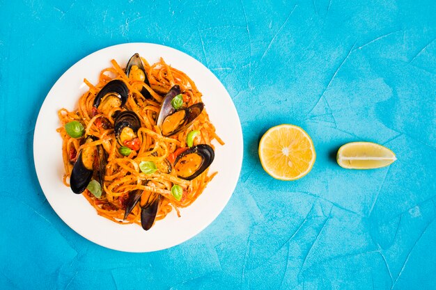 Flat-lay plate of pasta with mussels 
