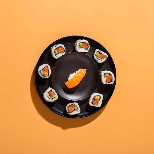 Flat lay plate of sushi rolls with nigiri