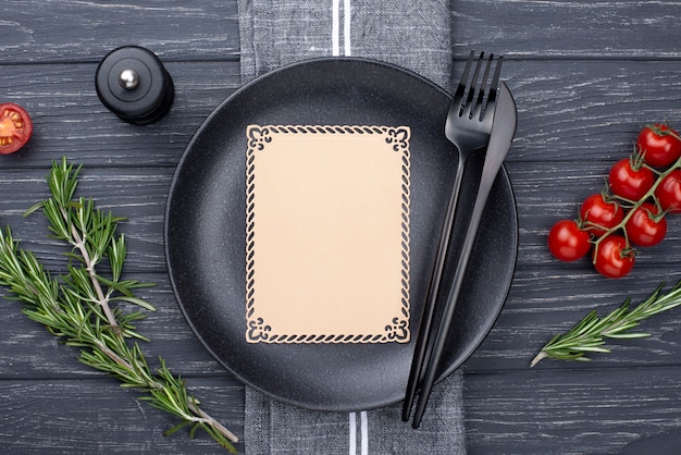 Flat lay plate with cutlery and tomatoes