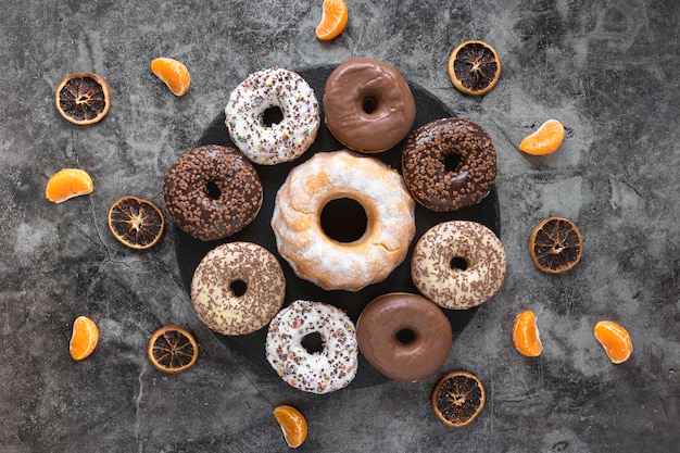 Flat lay of plate with doughnuts and citrus