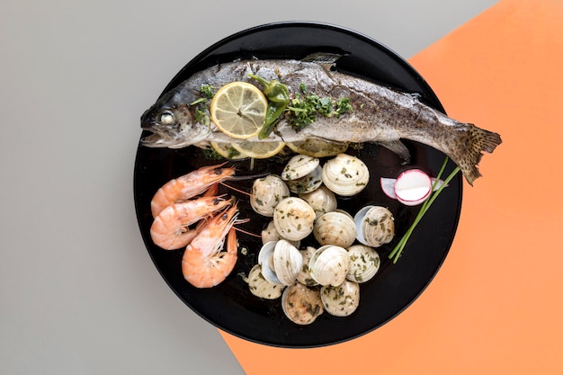 Flat lay of plate with fish and clams