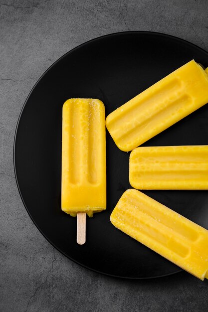 Flat lay plate with ice cream on stick