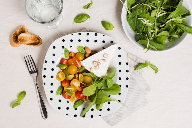 Flat lay of plate with organic vegetables and salad