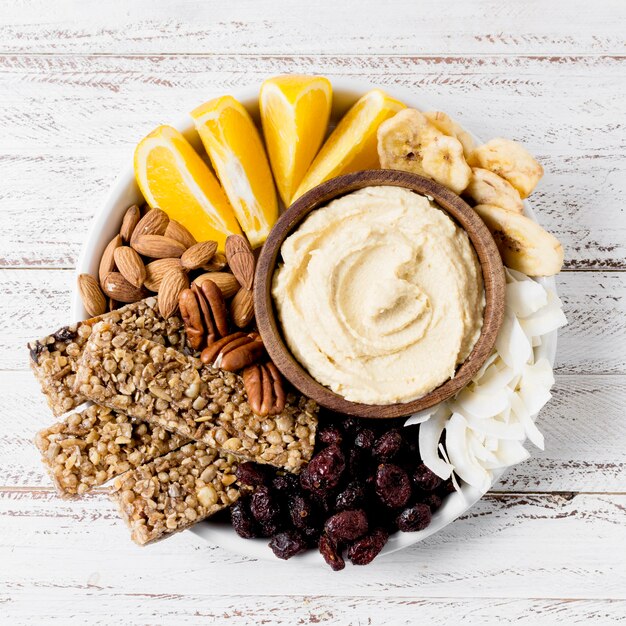 Flat lay of plate with variety of nuts and dip