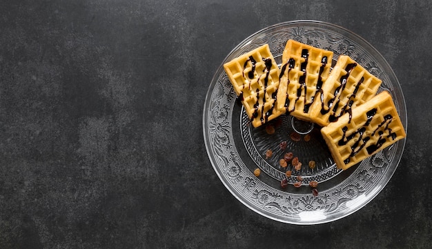 Flat lay of plate with waffles and copy space