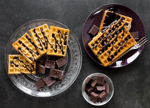 Flat lay of plates with waffles and chocolate