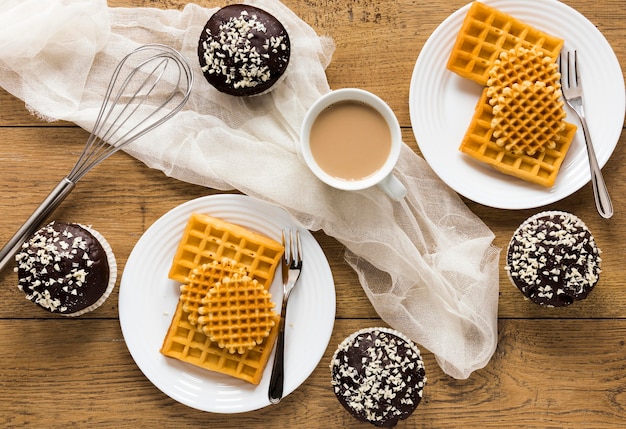 Flat lay of plates with waffles and coffee