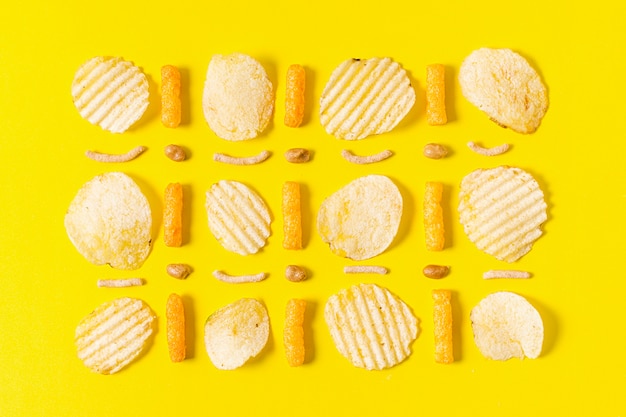 Flat lay of potato chips and cheesy puffs