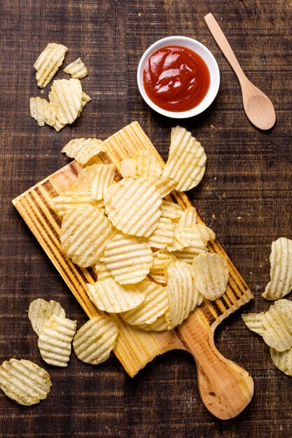 Flat lay of potato chips with ketchup