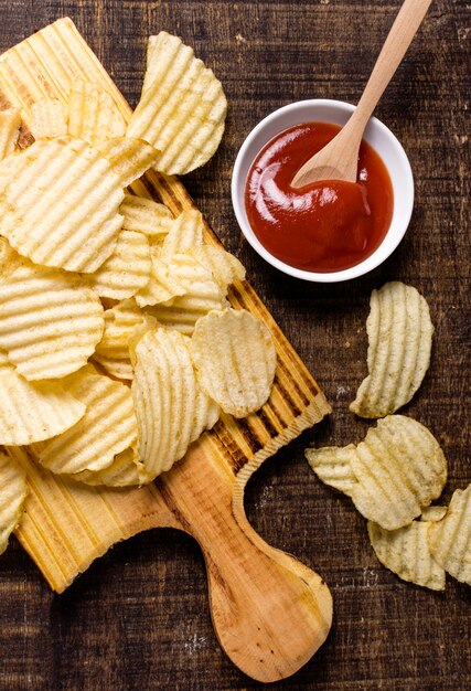 Flat lay of potato chips with ketchup